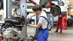 Automotive mechatronics technician works in a car repair shop