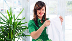 a housekeeper sorts laundry