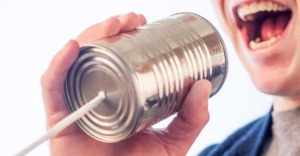 Teenager with tin can telephone