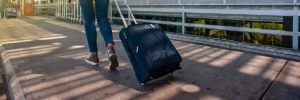 Airport arrival - Woman walking on pathway with luggage