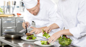 two chefs preparing meals