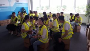 Group of students from Chongqing / China is sitting in the welcome room of Amazon Leipzig