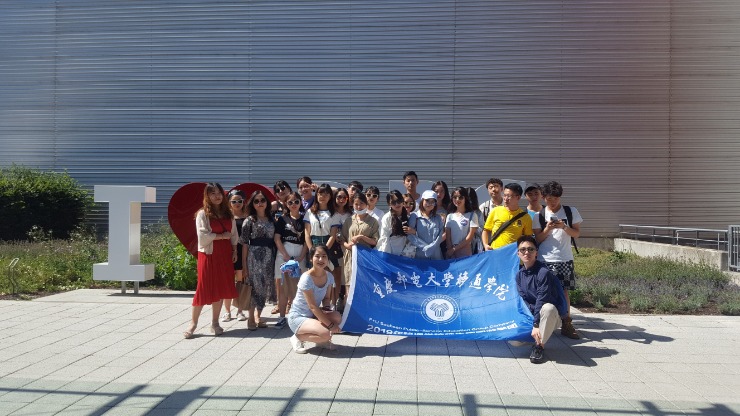 Group of students from Chongqing / China standing in front of the Airport Dresden